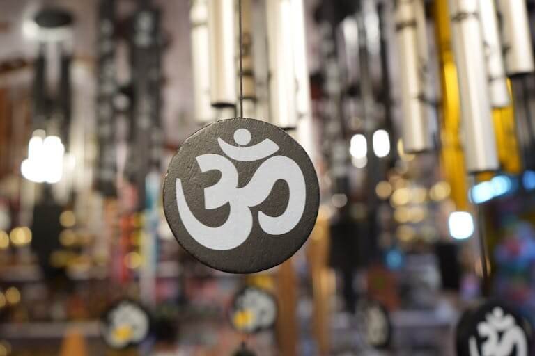 Close-up of a decorative Om symbol on a hanging ornament, perfect for spiritual and meditative themes.